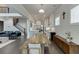 View of an open floorplan with the dining room, kitchen, and living room featuring hardwood floors and neutral paint at 1459 Bennett Creek Ovlk, Suwanee, GA 30024