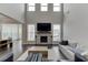Living room featuring a fireplace, hardwood floors and large, bright windows at 1459 Bennett Creek Ovlk, Suwanee, GA 30024