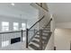 Elegant staircase with dark wood and iron railing, offering an airy, open feel at 1459 Bennett Creek Ovlk, Suwanee, GA 30024