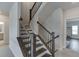 Staircase with dark wood railings leading to the upper level of the home at 1459 Bennett Creek Ovlk, Suwanee, GA 30024
