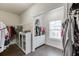 Well-organized walk-in closet with custom shelving and ample storage, enhancing convenience and tidiness at 1459 Bennett Creek Ovlk, Suwanee, GA 30024