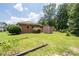 Spacious backyard featuring a garden area, storage shed, and mature trees for privacy at 2880 Sherwood Se Rd, Smyrna, GA 30082