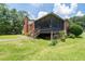 A charming brick home with a screened-in porch overlooking a well-maintained backyard at 2880 Sherwood Se Rd, Smyrna, GA 30082