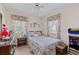 Charming bedroom featuring a floral bedspread, dresser, and bright windows at 2880 Sherwood Se Rd, Smyrna, GA 30082