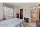 Cozy bedroom with floral bedding, window with curtains, and dark wood furniture at 2880 Sherwood Se Rd, Smyrna, GA 30082