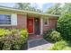 Charming brick home entrance with a bright red door and decorative wrought iron accents at 2880 Sherwood Se Rd, Smyrna, GA 30082