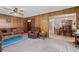 Open living room featuring wood paneling, carpet, and seamless access to the dining area at 2880 Sherwood Se Rd, Smyrna, GA 30082