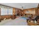 Cozy living room with brick fireplace, wood paneling and comfortable seating at 2880 Sherwood Se Rd, Smyrna, GA 30082