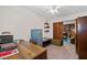 Home office with a large wooden desk, filing cabinet, and decorative shelves at 2880 Sherwood Se Rd, Smyrna, GA 30082