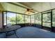Screened porch with a ceiling fan, outdoor dining set, and a view of lush greenery at 2880 Sherwood Se Rd, Smyrna, GA 30082