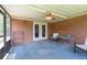 Screened porch with brick wall, ceiling fan, outdoor dining set and a view of the yard at 2880 Sherwood Se Rd, Smyrna, GA 30082