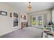 Inviting sunroom featuring a decorative chandelier, white brick walls and double doors at 2880 Sherwood Se Rd, Smyrna, GA 30082