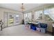 Bright sunroom featuring large windows, a chandelier, and ample storage at 2880 Sherwood Se Rd, Smyrna, GA 30082