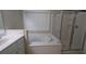 Well-lit bathroom with jetted tub, glass shower, and vanity at 3618 Prescot Way, Douglasville, GA 30135