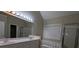 Bright bathroom featuring double sinks, a large mirror, soaking tub, and glass-enclosed shower at 3618 Prescot Way, Douglasville, GA 30135