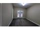 Neutral bedroom featuring a door to the back porch and a window that provides natural light at 3618 Prescot Way, Douglasville, GA 30135
