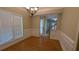 Dining room featuring hardwood floors, wainscoting, chandelier, and entrance to other areas at 3618 Prescot Way, Douglasville, GA 30135