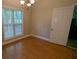 Traditional dining room with hardwood floors, bright window, and chandelier lighting at 3618 Prescot Way, Douglasville, GA 30135