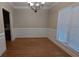 Charming dining room with hardwood floors, chandelier, and natural light from the large window at 3618 Prescot Way, Douglasville, GA 30135
