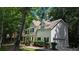 Traditional two-story home features a white exterior, black shutters and attached garage nestled among mature trees at 3618 Prescot Way, Douglasville, GA 30135