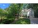 Traditional two-story home features a white exterior, black shutters and attached garage nestled among mature trees at 3618 Prescot Way, Douglasville, GA 30135