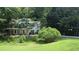 Charming two-story home with a welcoming front porch and surrounded by lush greenery at 3618 Prescot Way, Douglasville, GA 30135