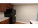 Kitchen area with black refrigerator, wooden cabinets, and view of countertop and wall at 3618 Prescot Way, Douglasville, GA 30135