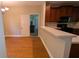 Kitchen with view to dining room, wood floors, and doorway to the garage at 3618 Prescot Way, Douglasville, GA 30135