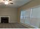 Living room featuring a fireplace, carpeted floors, and large windows with blinds for natural light at 3618 Prescot Way, Douglasville, GA 30135