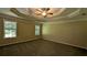 Spacious main bedroom with tray ceiling, ceiling fan, and large windows at 3618 Prescot Way, Douglasville, GA 30135