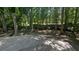 Concrete patio area provides ample space for outdoor entertaining among mature trees at 3618 Prescot Way, Douglasville, GA 30135