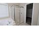Modern bathroom featuring a glass-enclosed shower, jetted tub, and walk-in closet at 3618 Prescot Way, Douglasville, GA 30135