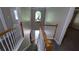 View from the top of staircase showcasing foyer, chandelier, and arched window at 3618 Prescot Way, Douglasville, GA 30135