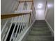 Carpeted staircase with wood railing and white balusters leading to the upper level at 3618 Prescot Way, Douglasville, GA 30135