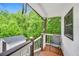 Relaxing porch with a view of lush greenery and an outbuilding at 1029 Megan Ct, Sugar Hill, GA 30518