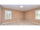 Bedroom with two windows providing natural light and carpet flooring at 166 Muse Rd, Fayetteville, GA 30214