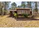 Cozy one-story home featuring a wall of windows and surrounded by mature trees at 166 Muse Rd, Fayetteville, GA 30214