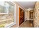Inviting foyer with stone accents, showcasing wood doors, sleek flooring, and natural light, a perfect entrance at 166 Muse Rd, Fayetteville, GA 30214