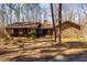 Charming ranch-style house with stone and wood exterior, set amidst mature trees, offers a peaceful retreat at 166 Muse Rd, Fayetteville, GA 30214