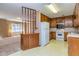 View from living room to the kitchen featuring wood cabinets and appliances at 166 Muse Rd, Fayetteville, GA 30214