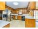 The kitchen is equipped with stainless steel appliances and wood cabinets at 166 Muse Rd, Fayetteville, GA 30214