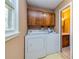 Laundry room with washer and dryer, wooden cabinets above at 166 Muse Rd, Fayetteville, GA 30214