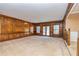 Spacious living room features wood paneling, carpet, and large windows, offering a warm and inviting atmosphere at 166 Muse Rd, Fayetteville, GA 30214