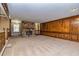 Expansive living room with a stone fireplace and wood paneling provides a cozy yet elegant space for relaxation at 166 Muse Rd, Fayetteville, GA 30214