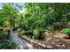 Landscaped backyard featuring a stone pathway and serene pond with koi fish at 3152 Sycamore Ln, Marietta, GA 30066