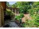 Landscaped backyard with stone steps leading to a sunroom and lush garden area at 3152 Sycamore Ln, Marietta, GA 30066