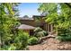 Spacious backyard with mature trees, well-manicured shrubs, and a multi-level deck area at 3152 Sycamore Ln, Marietta, GA 30066