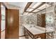 Compact bathroom with marble countertop and light-reflecting seashell themed wallpaper at 3152 Sycamore Ln, Marietta, GA 30066