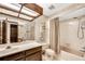 Unique bathroom with marble countertop, seashell themed wallpaper, and tiled shower at 3152 Sycamore Ln, Marietta, GA 30066