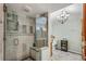Bathroom showcasing modern shower, chandelier, and vanity with ample storage at 3152 Sycamore Ln, Marietta, GA 30066